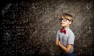 26179155-genius-boy-in-red-glasses-near-blackboard-with-formulas-stock-photo